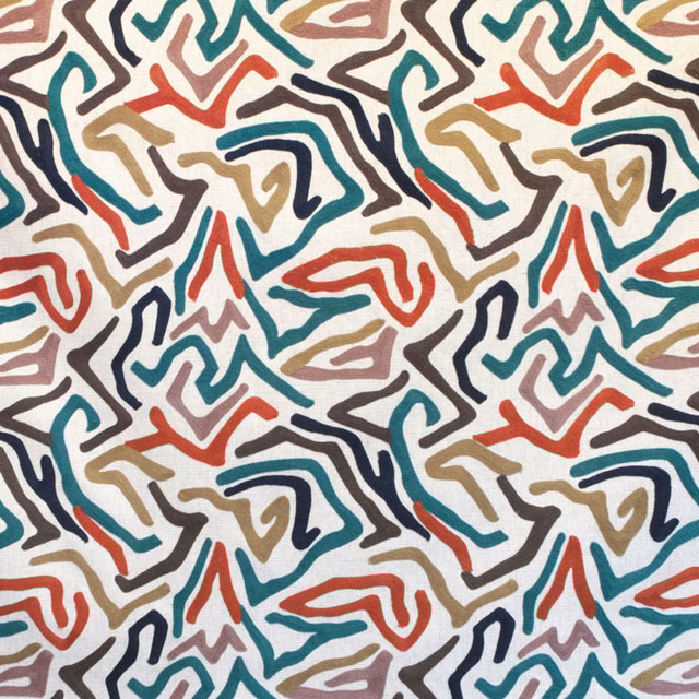 Abstract multicolour embroidered-style zigzags on a white fabric ground