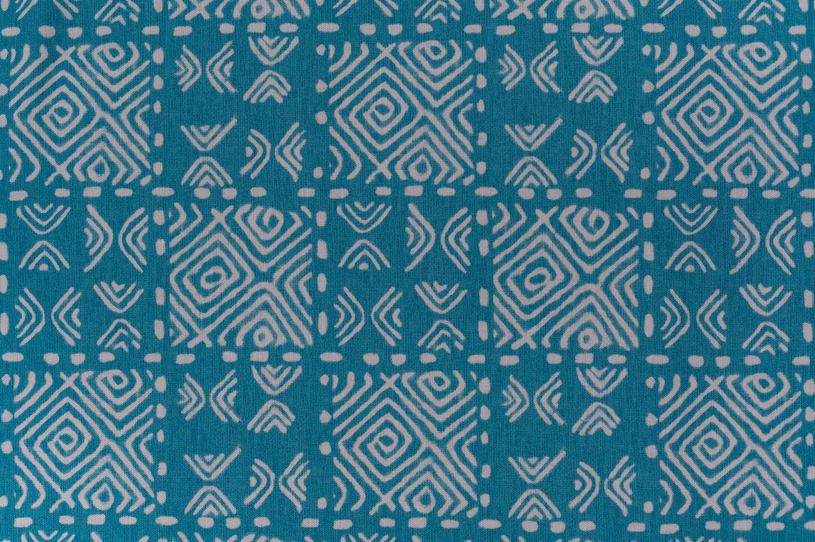 Teal geometric fabric swatch with pale diamond and chevron repeat