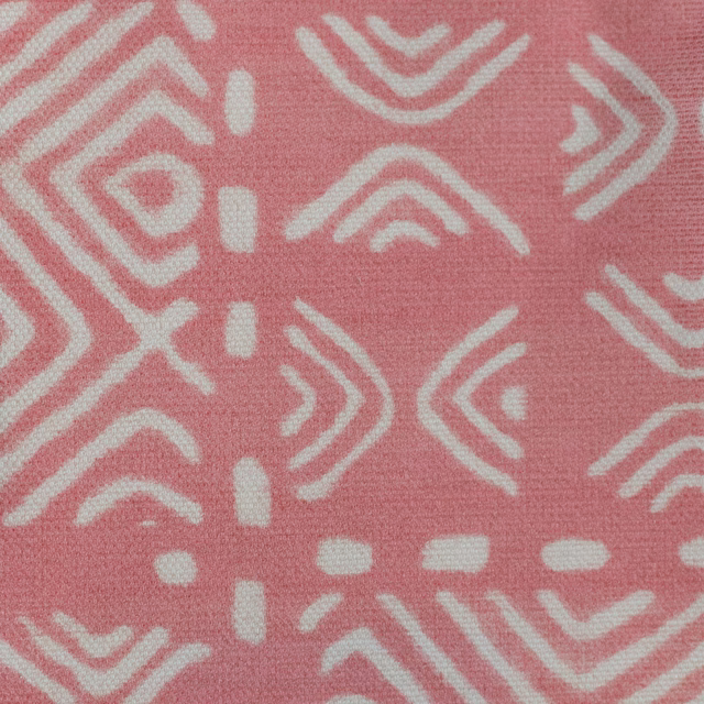 Pink woven fabric swatch with ivory geometric motifs and a soft textured finish