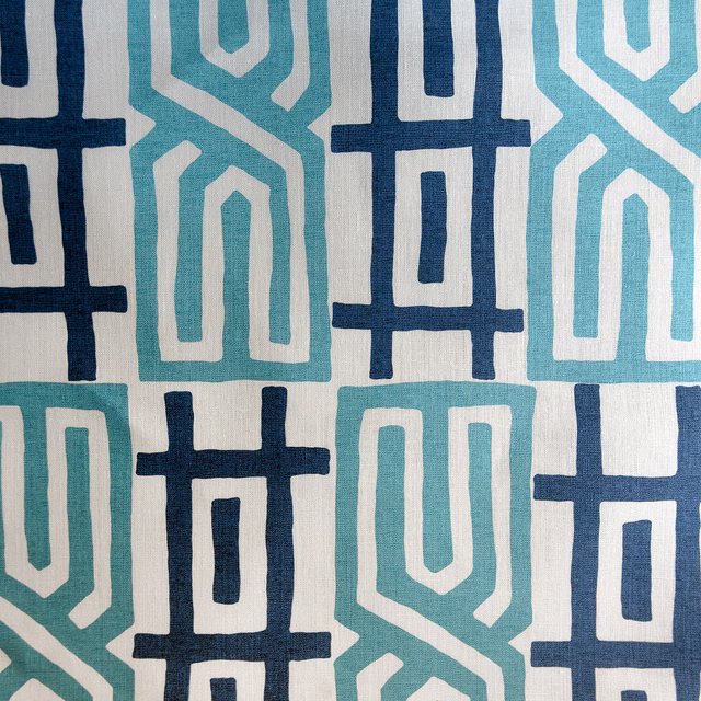 Large navy and aqua geometric fabric on a pale woven ground