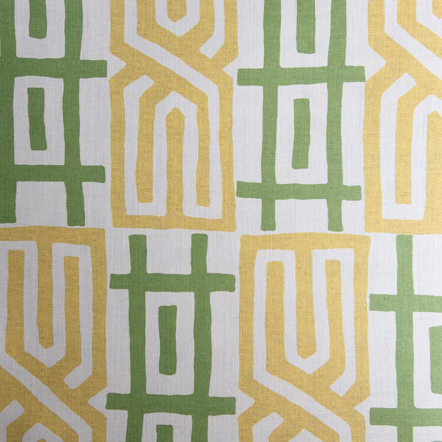 Large geometric fabric swatch in sage green and buttery yellow on a pale ground