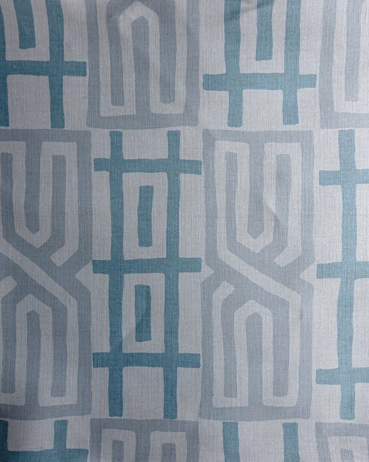 Blue and grey geometric woven fabric swatch with large repeating motifs