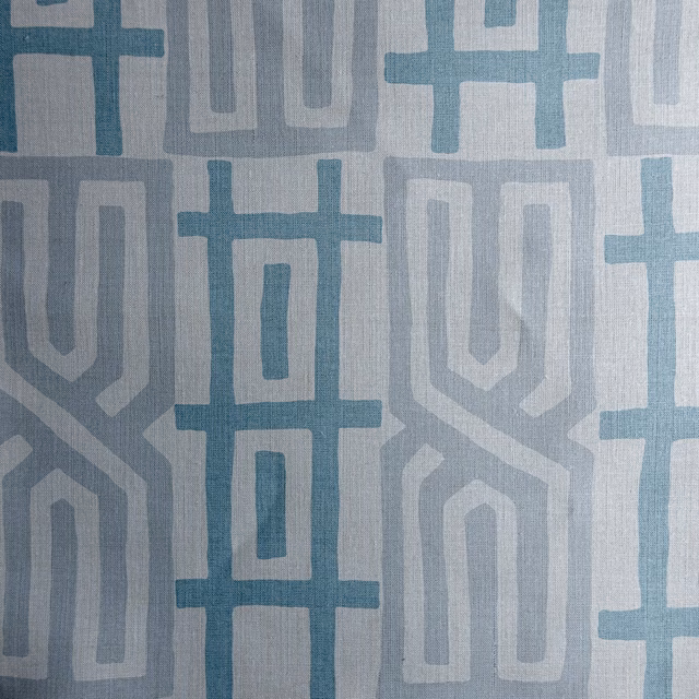 Blue and grey geometric woven fabric swatch with large repeating motifs