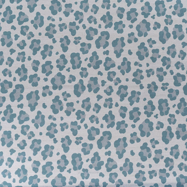 Pale fabric swatch with small aqua leopard spots on a light ground