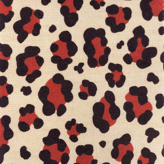 Beige woven fabric with red and black leopard spot print