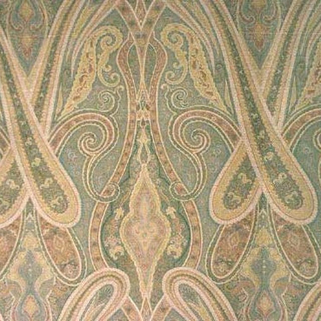 Muted sage green damask fabric with cream scrolling motifs and aged beige details