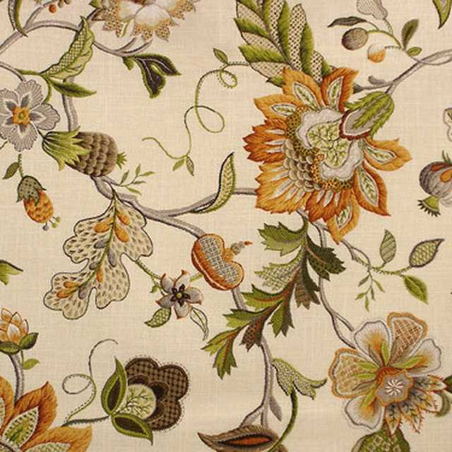 Ochre floral upholstery fabric with cream ground, green leaves and rust accents