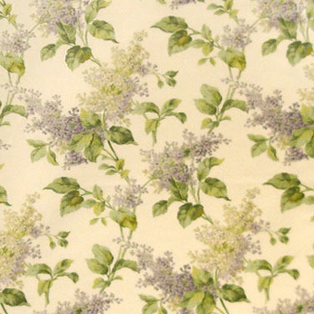 Cream fabric swatch with scattered lilac blossoms and green leaves