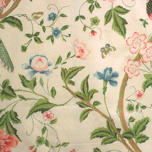 Floral and bird botanical fabric on a warm cream ground with pink and green detail