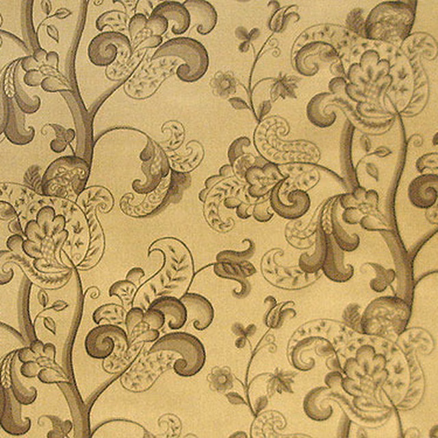 Brown and gold scrolling floral fabric on a pale beige ground