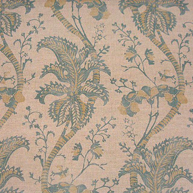 Large celadon botanical leaves and stems on a warm pale neutral fabric