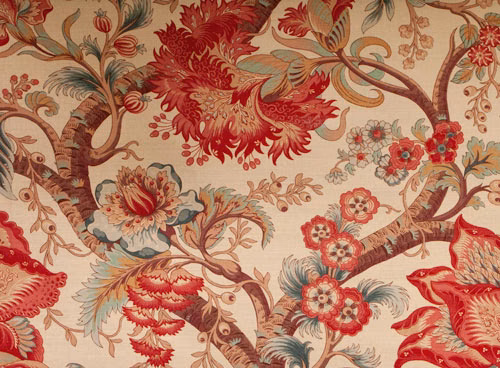 Large botanical fabric swatch in warm red, cream and blue-green floral branches