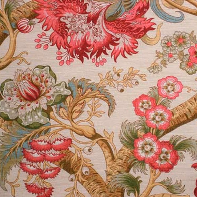 Large-scale botanical fabric with coral pink flowers, gold branches and ivory ground