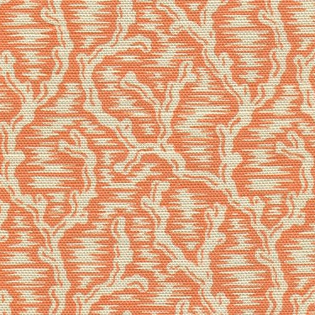 Coral orange woven fabric with an ivory damask-style pattern