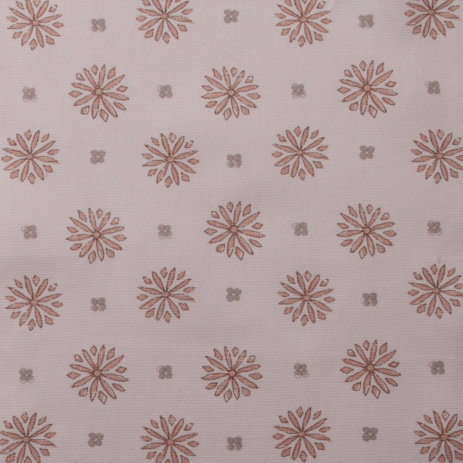 Soft blush pink printed fabric with spaced floral rosettes and tiny motif dots