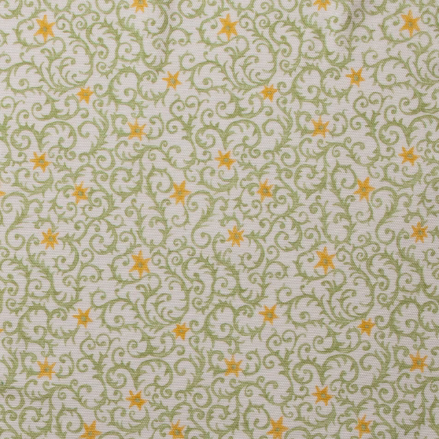 Pale cotton swatch with grassy green filigree scrolls and small ochre star motifs