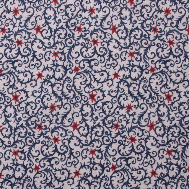 Small-scale blue filigree print with red star motifs on a pale cotton ground