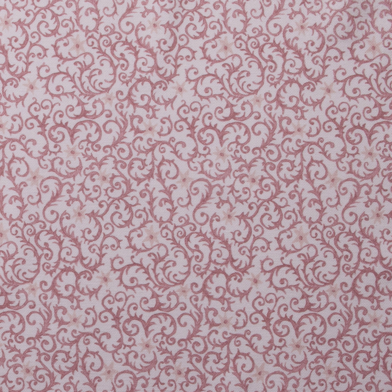 Dusty rose scrolling filigree print on a pale blush cotton ground