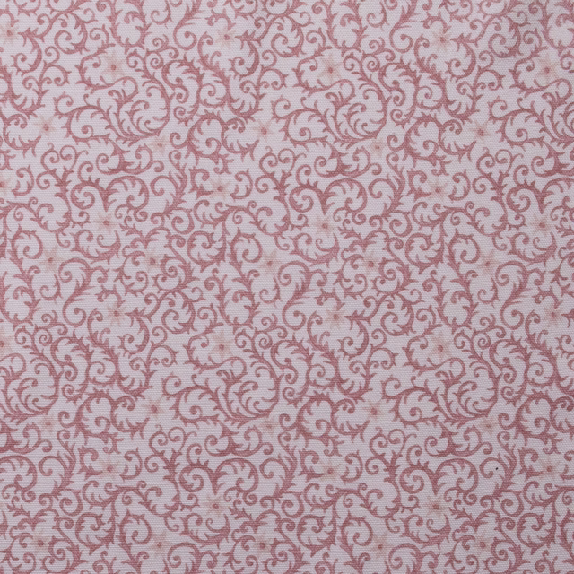 Dusty rose scrolling filigree print on a pale blush cotton ground