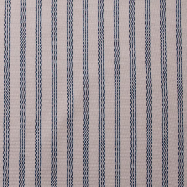 Pale cotton fabric with narrow denim-blue vertical pinstripes on a light ground