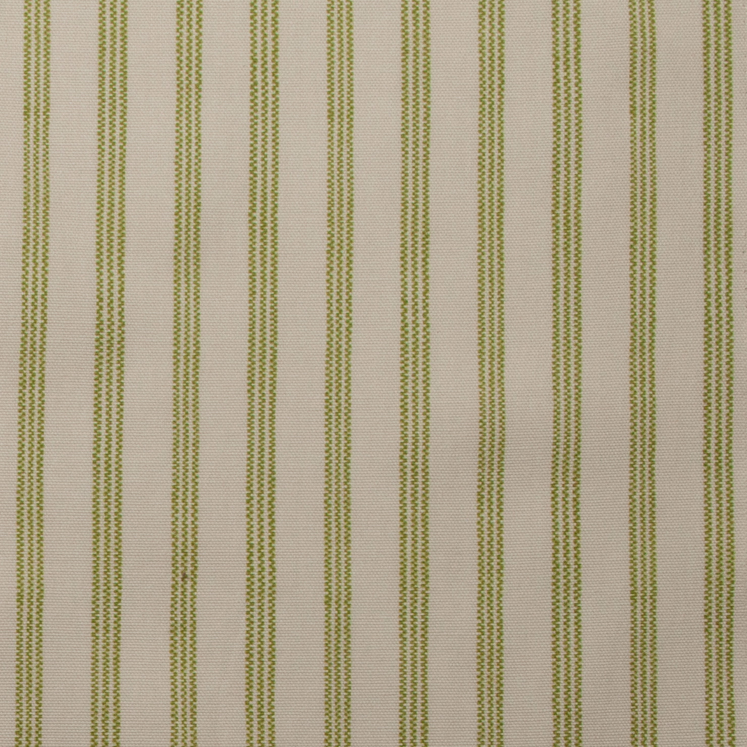 Close-up of cream cotton fabric with slim pistachio green vertical stripes