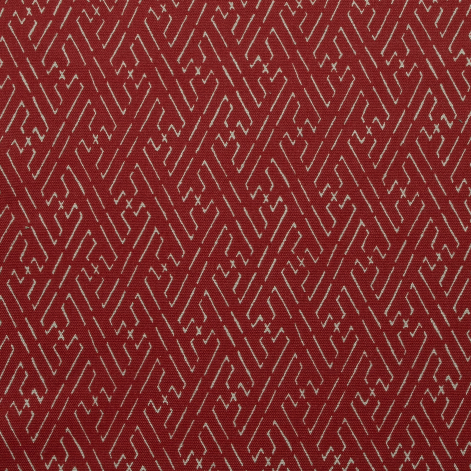 Red geometric trellis print with pale zigzag lines on cotton