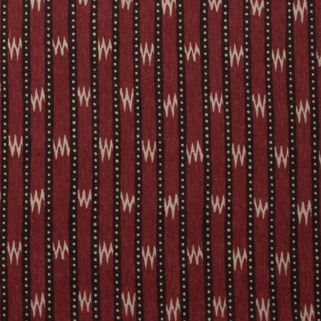 Vertical chocolate-red stripes with cream zigzags and dotted accents on cotton