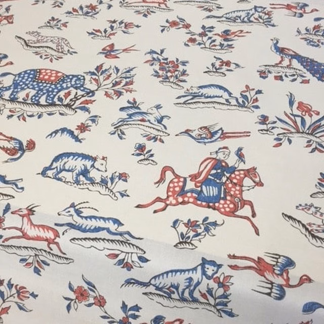 Ivory printed fabric with red and blue safari animals and riders
