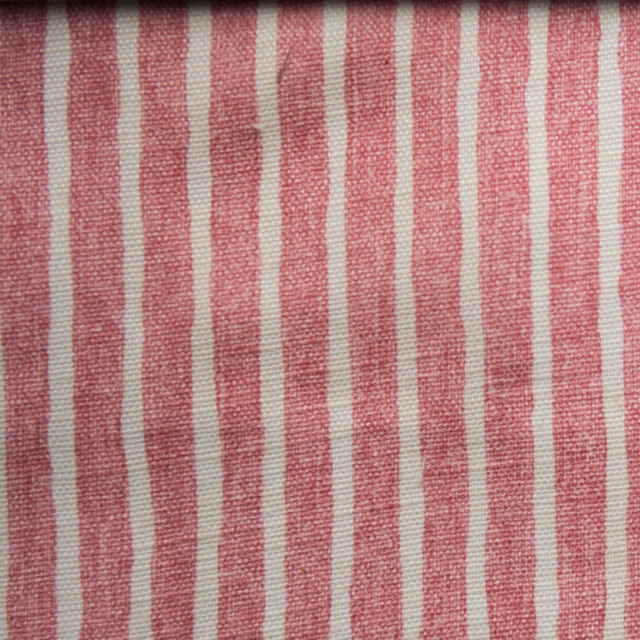 Vertical dusty pink and off-white striped woven fabric with a soft texture
