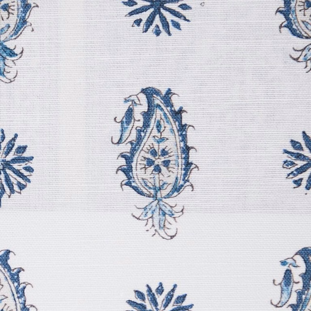 Close-up of indigo and pale blue paisley motifs on a light woven ground