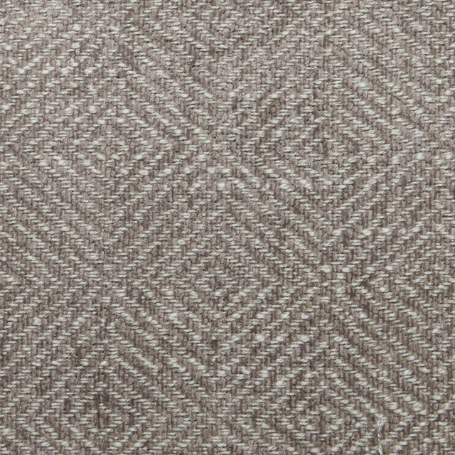 Close-up of a rose-beige geometric woven fabric with diamond motifs