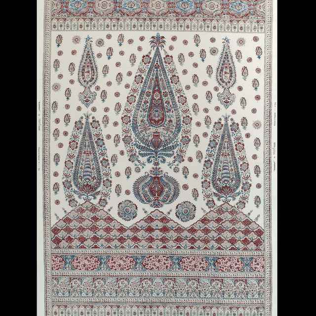 Cream kalamkari fabric with teal and red paisley motifs and border bands