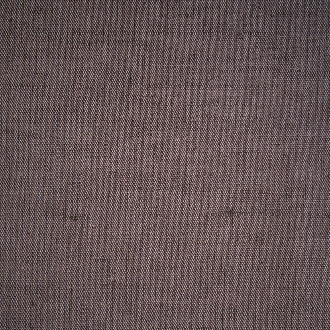 Close-up of a plain woven taupe fabric with fine texture and subtle heathering