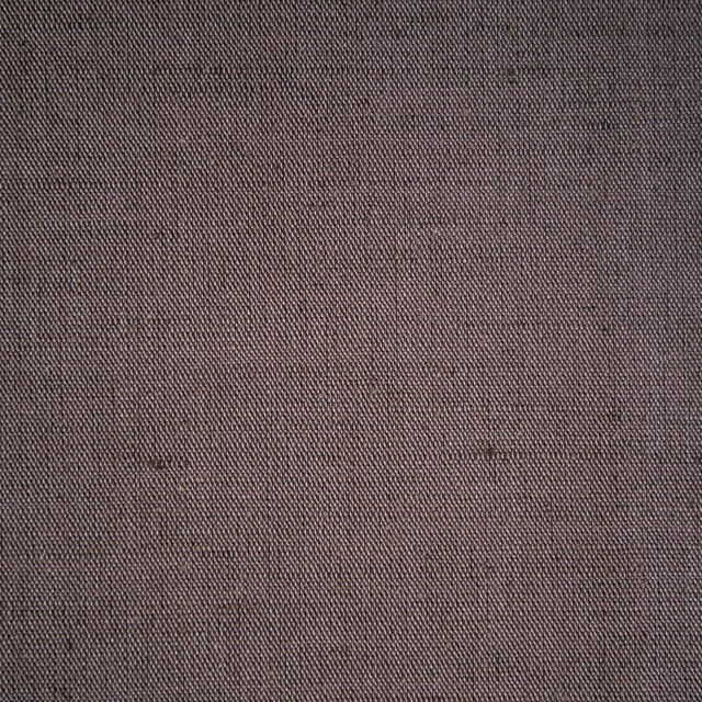 Close-up of a plain woven taupe fabric with fine texture and subtle heathering