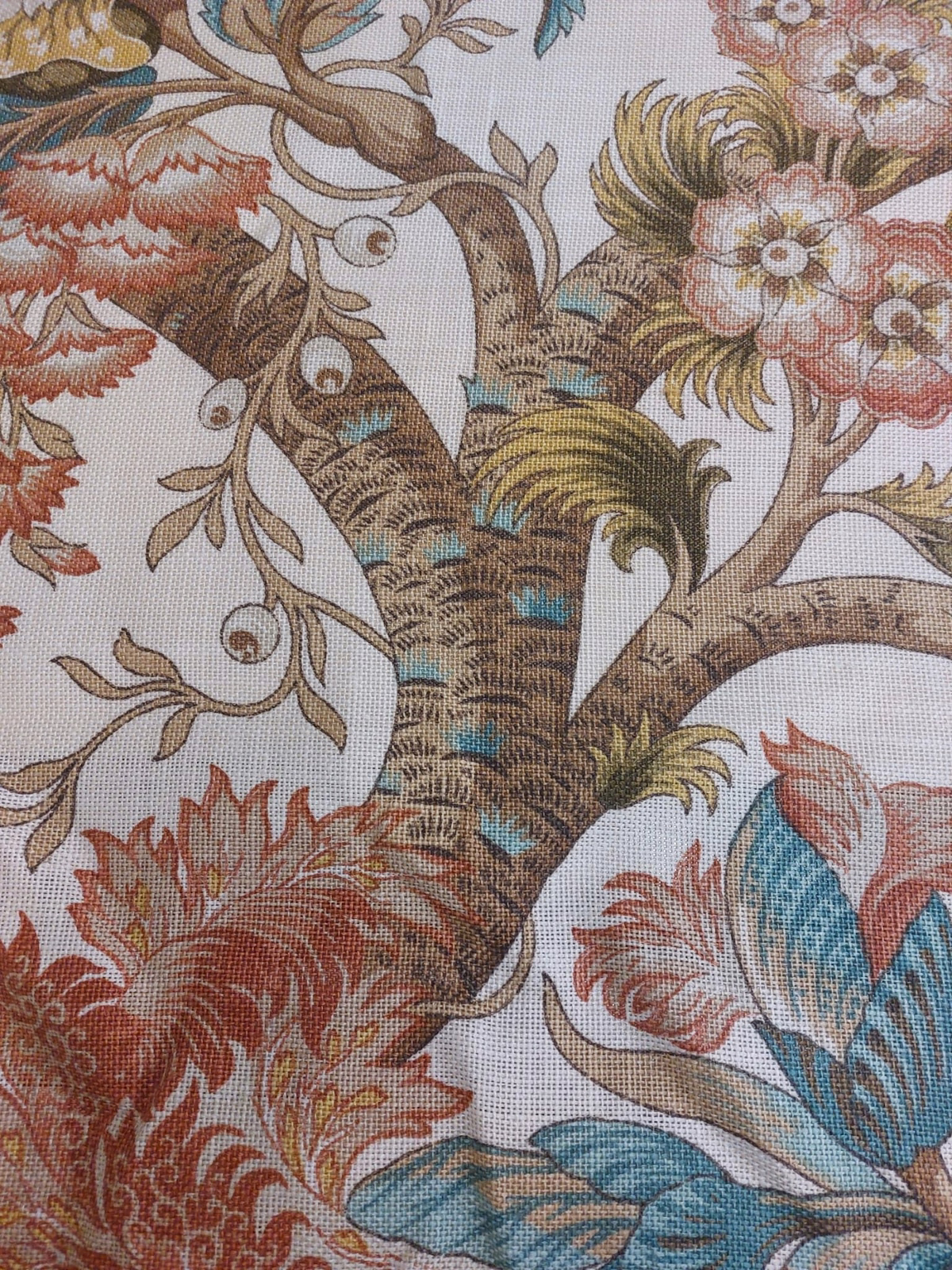 Close-up of tree-of-life floral fabric with taupe branches, teal accents and coral leaves