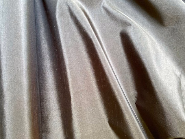 Pale pearl-grey taffeta with a glossy, softly folded surface