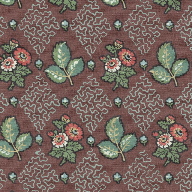 Burgundy printed fabric with green leaves, small flowers and looping motifs