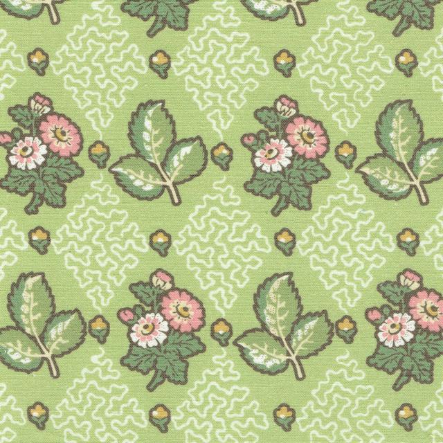 Bright green printed fabric with pink floral sprigs, pale leaves and white squiggle motifs