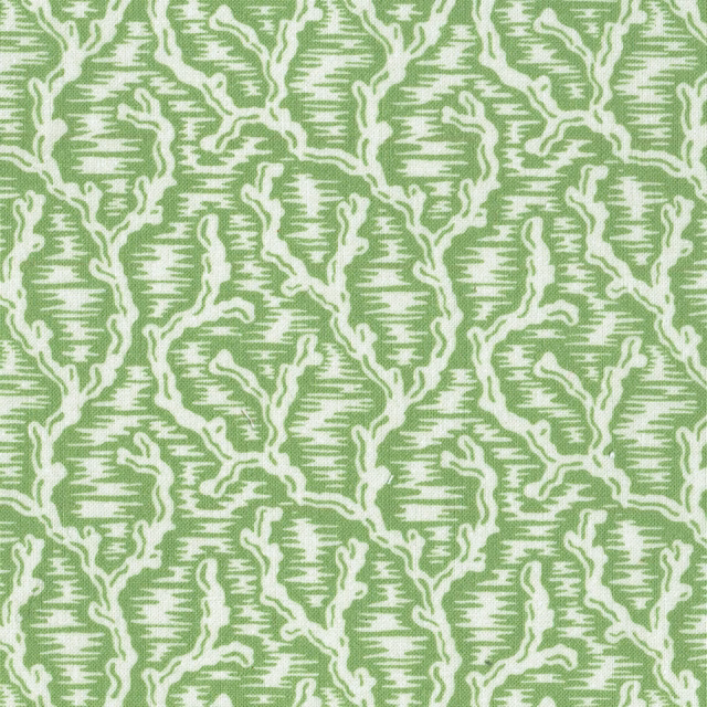 Green geometric fabric swatch with cream outlined lattice pattern