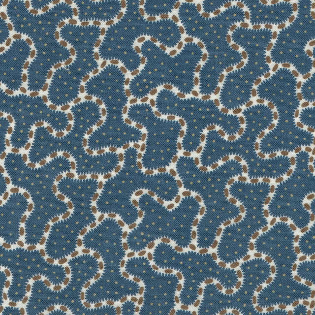 Blue patterned fabric with cream looping motif and tiny gold dots