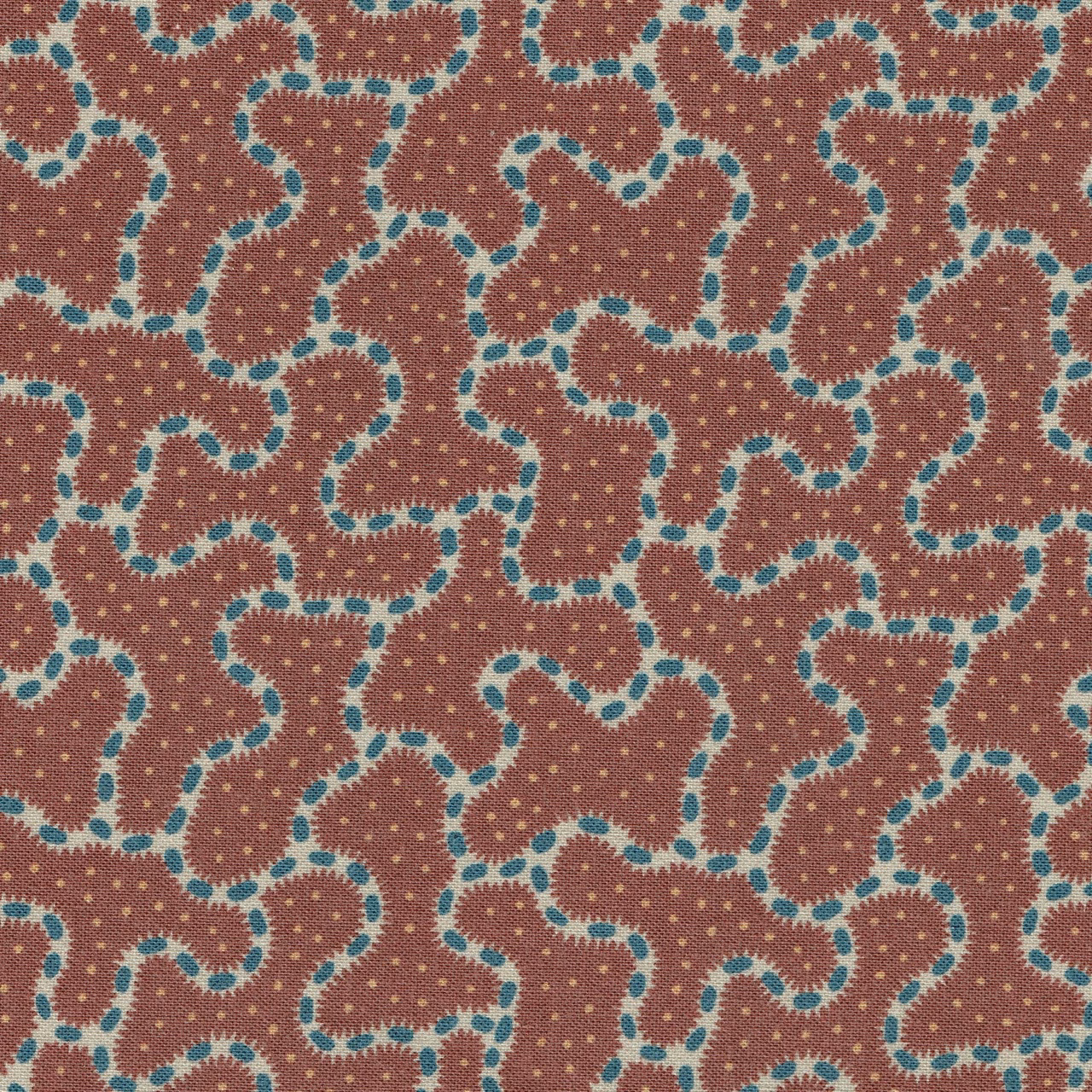 Close-up of a deep red geometric fabric with turquoise outlined loops and tiny dots