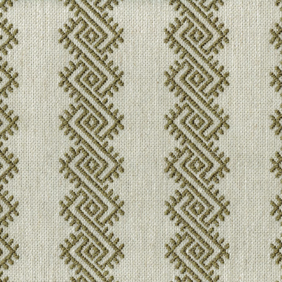 Close-up of geometric olive diamond embroidery on a pale woven fabric