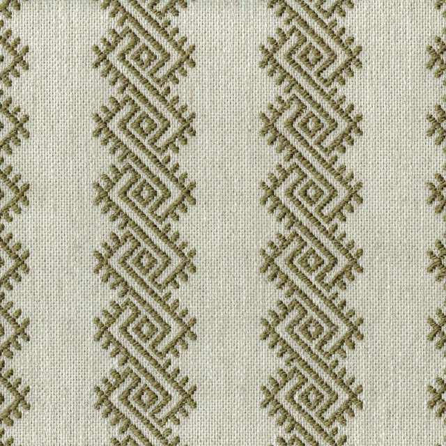 Close-up of geometric olive diamond embroidery on a pale woven fabric