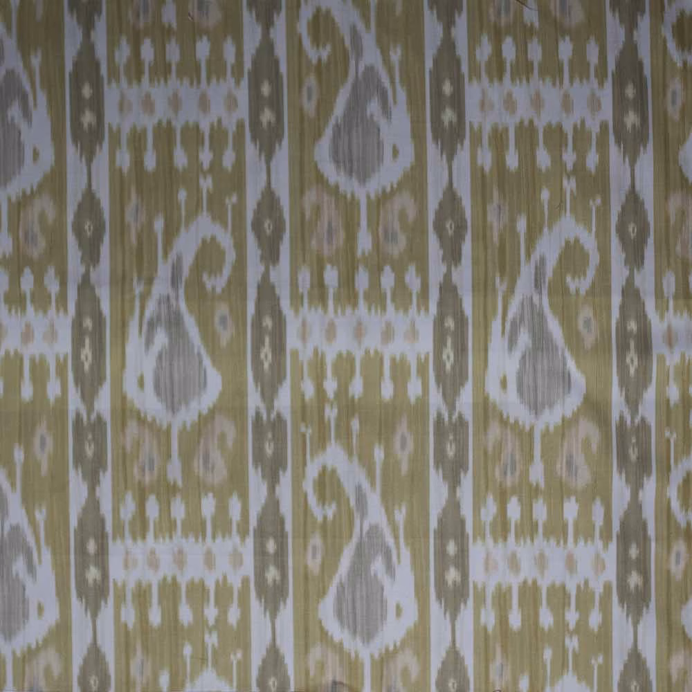 Ikat patterned fabric in muted mustard yellow, white and olive with a textured weave