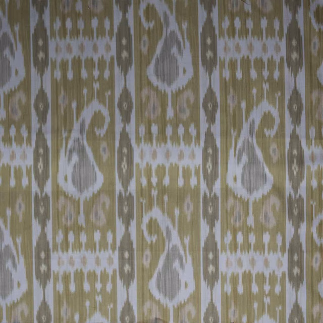 Ikat patterned fabric in muted mustard yellow, white and olive with a textured weave