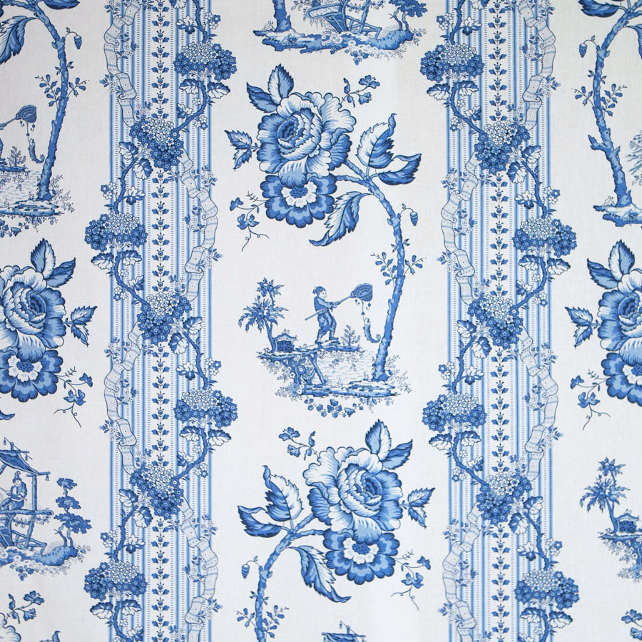 Blue chinoiserie toile fabric with large floral and scenic motifs on a pale ground