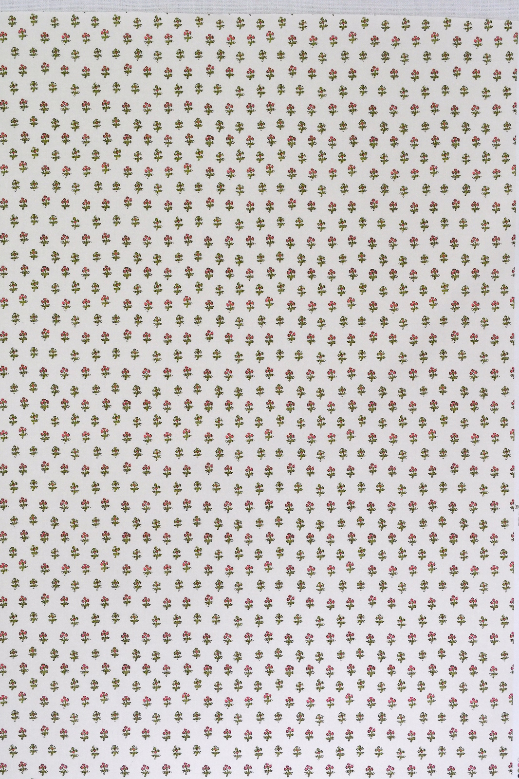 Ivory fabric swatch with tiny green, pink and brown floral sprigs