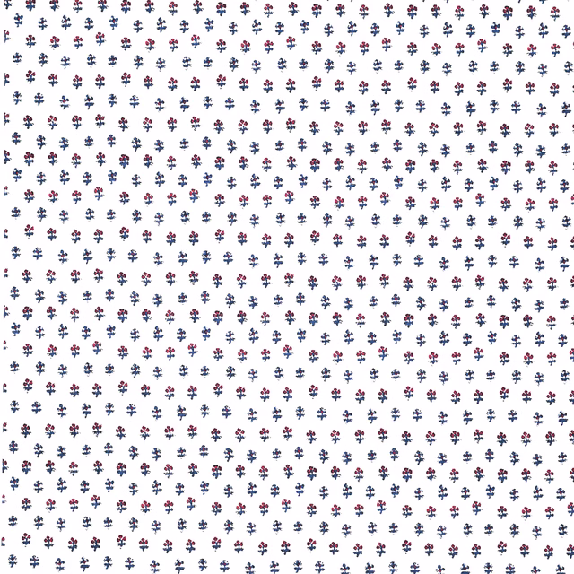 White fabric swatch with tiny navy and red sprig motif