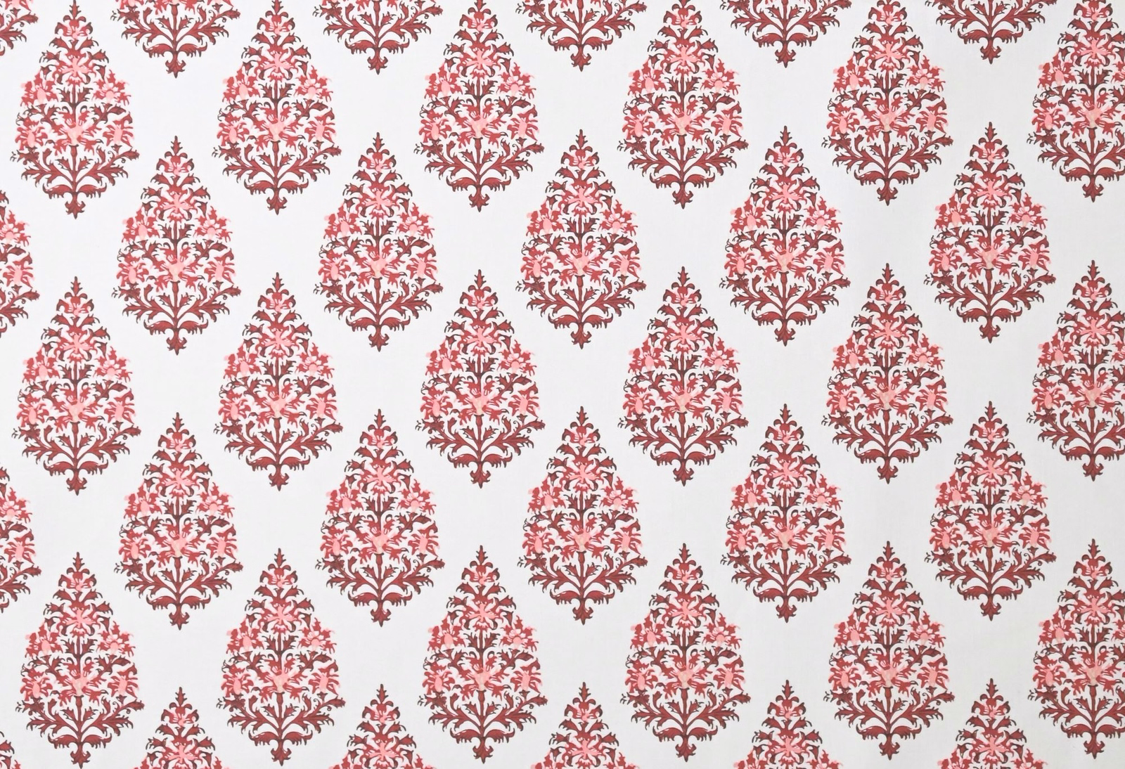 Dusty rose red damask motif on a pale off-white fabric ground