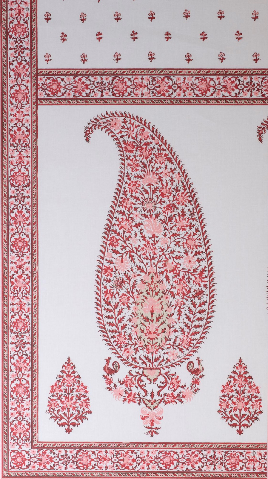 White fabric swatch with coral-red bordered paisley panel and floral damask motifs